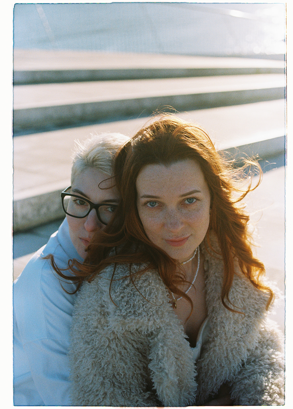 a portrait of two brides on their elopement in Lisbon's winter sun, shot on Kokak Colorplus 200 