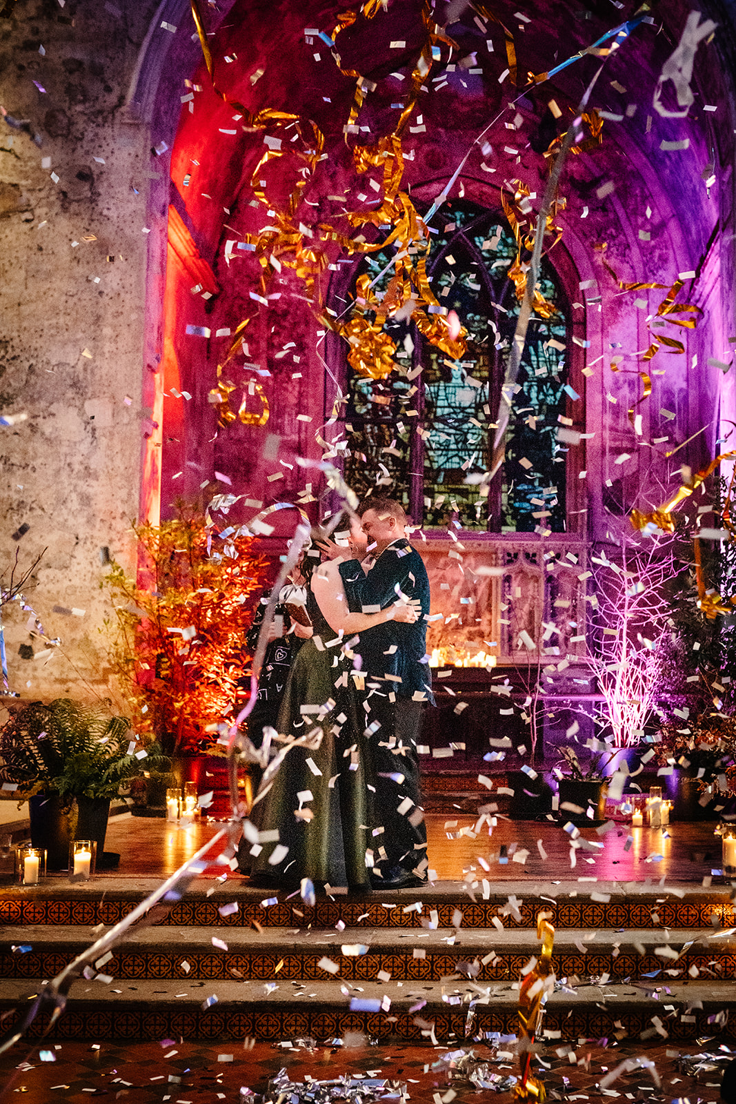 bride & groom celebrating getting married with confetti & streamer cannons