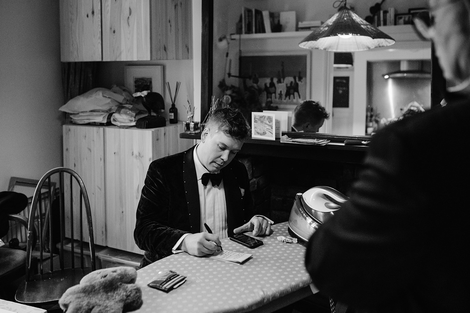 groom writing his speeches on ironing table