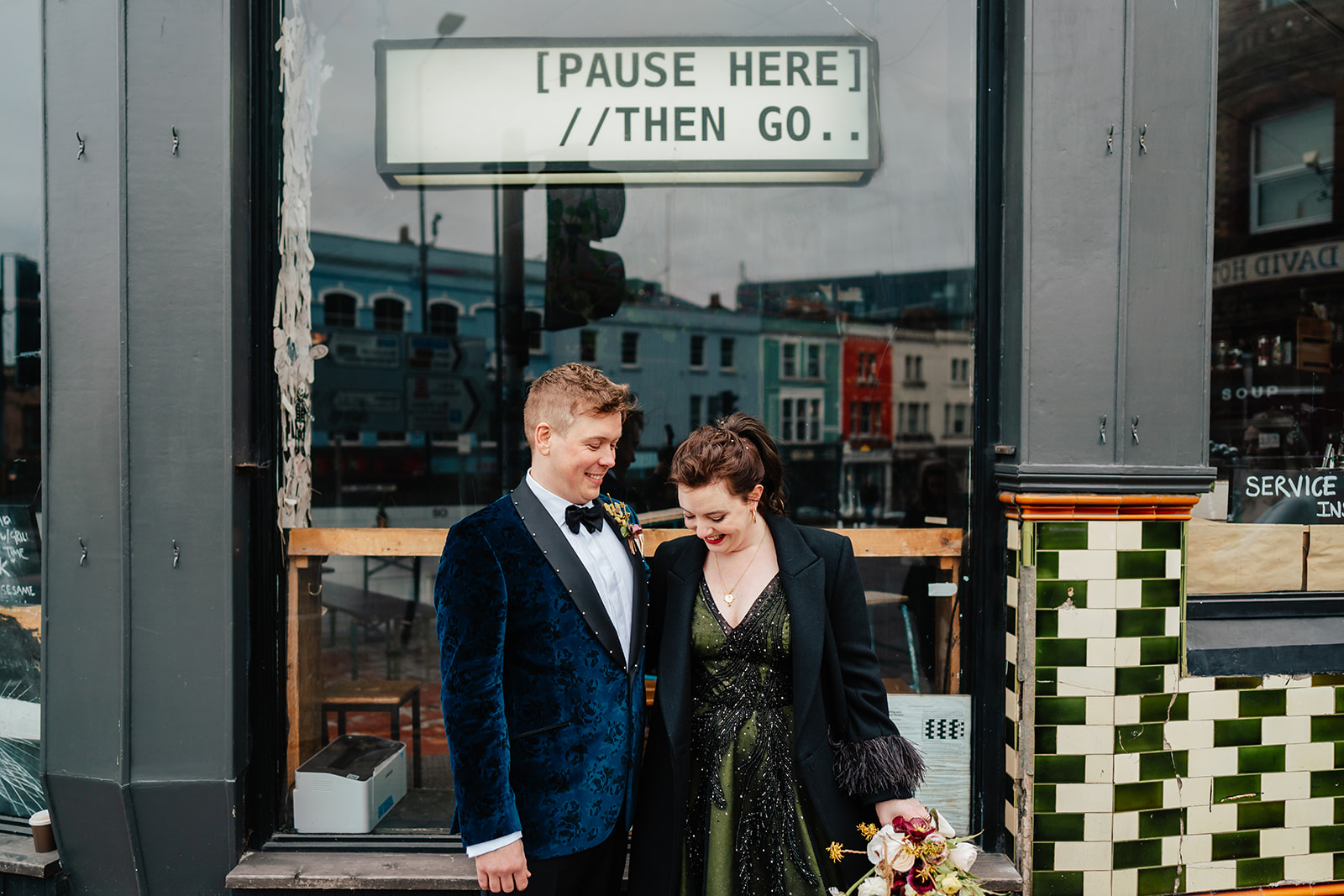 wedding couple in front of shop in Bristol