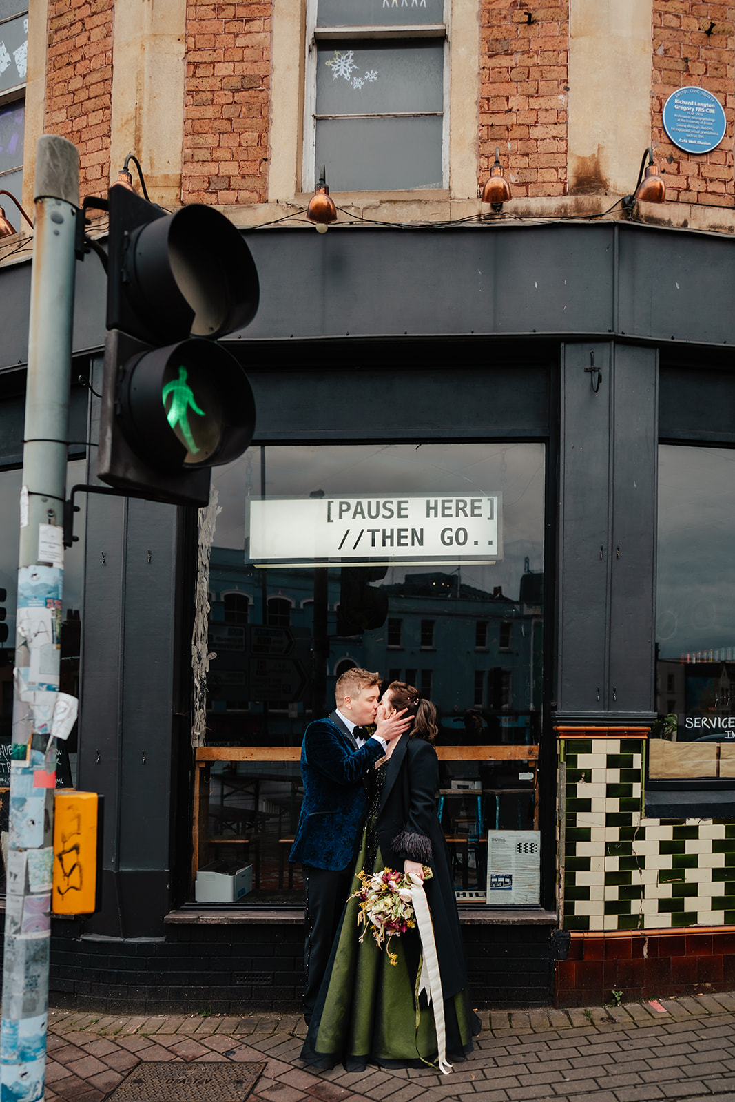 wedding couple kissing in front of shop in Bristol City