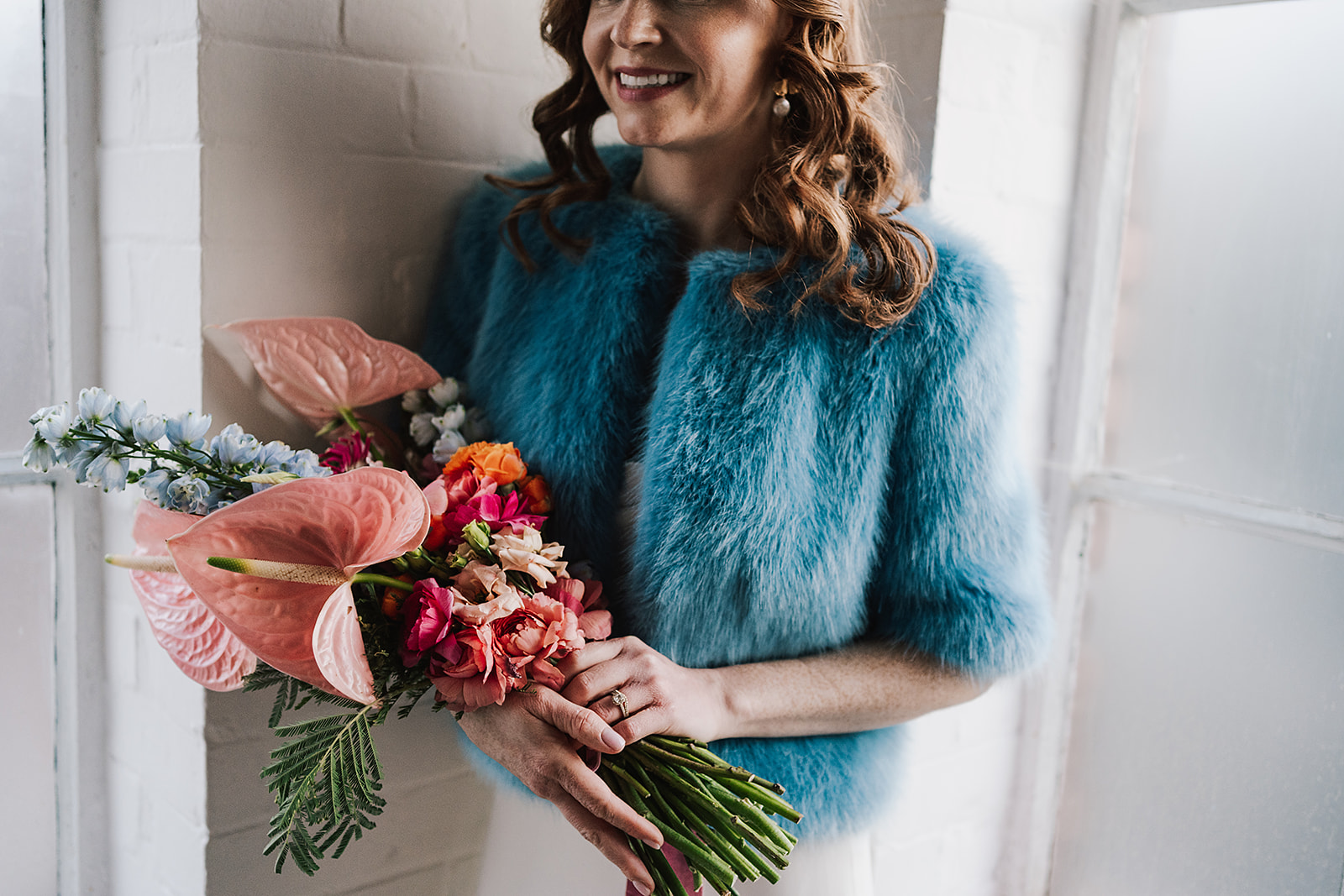 bride wearing blue shrimps coat at a wedding in One Friendly Place by Lisa jane photography