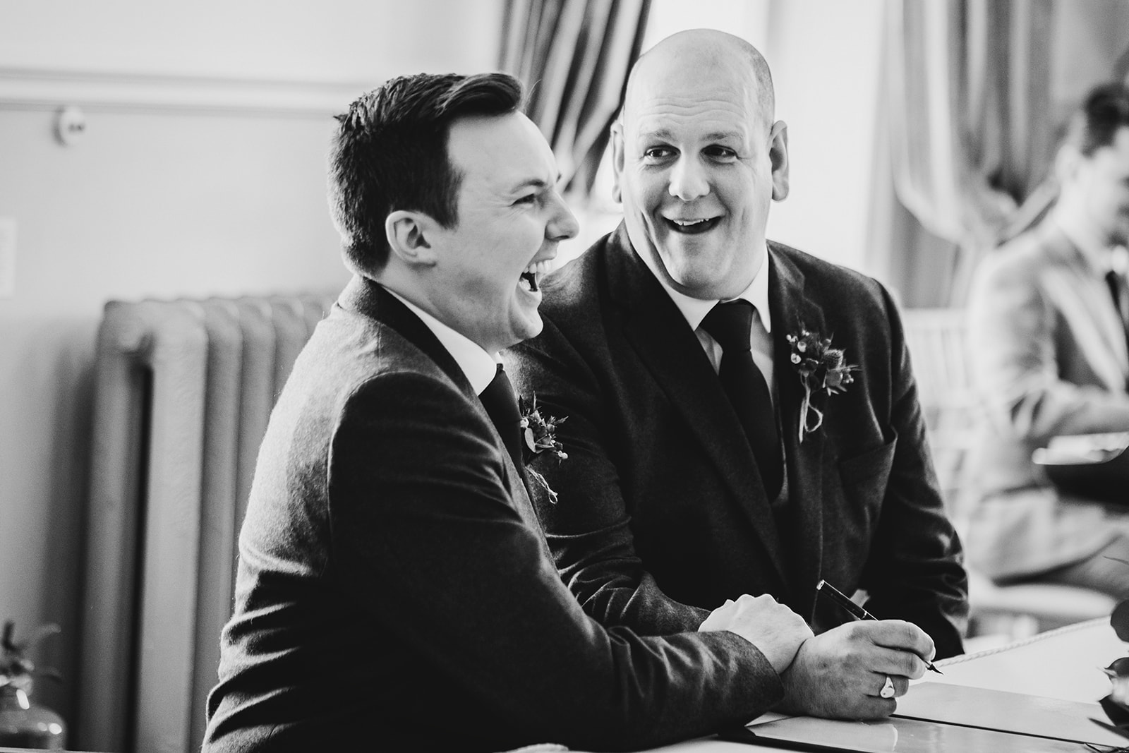 black and white photograph of the grooms signing the register