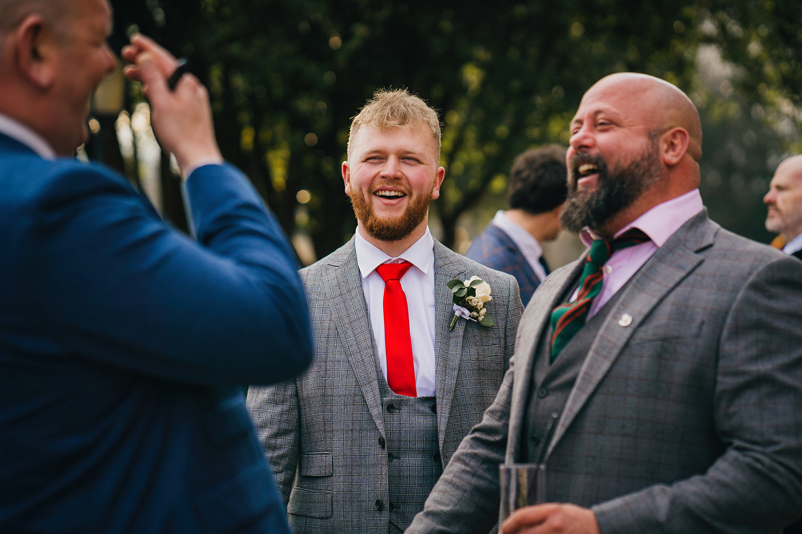wedding guests drinking beer and laughing at one another