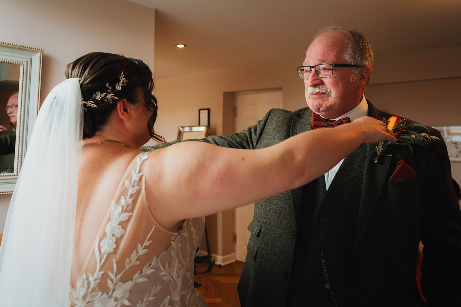 the father of the bride looking emotional as he sees his daughter in her wedding gown for the first time
