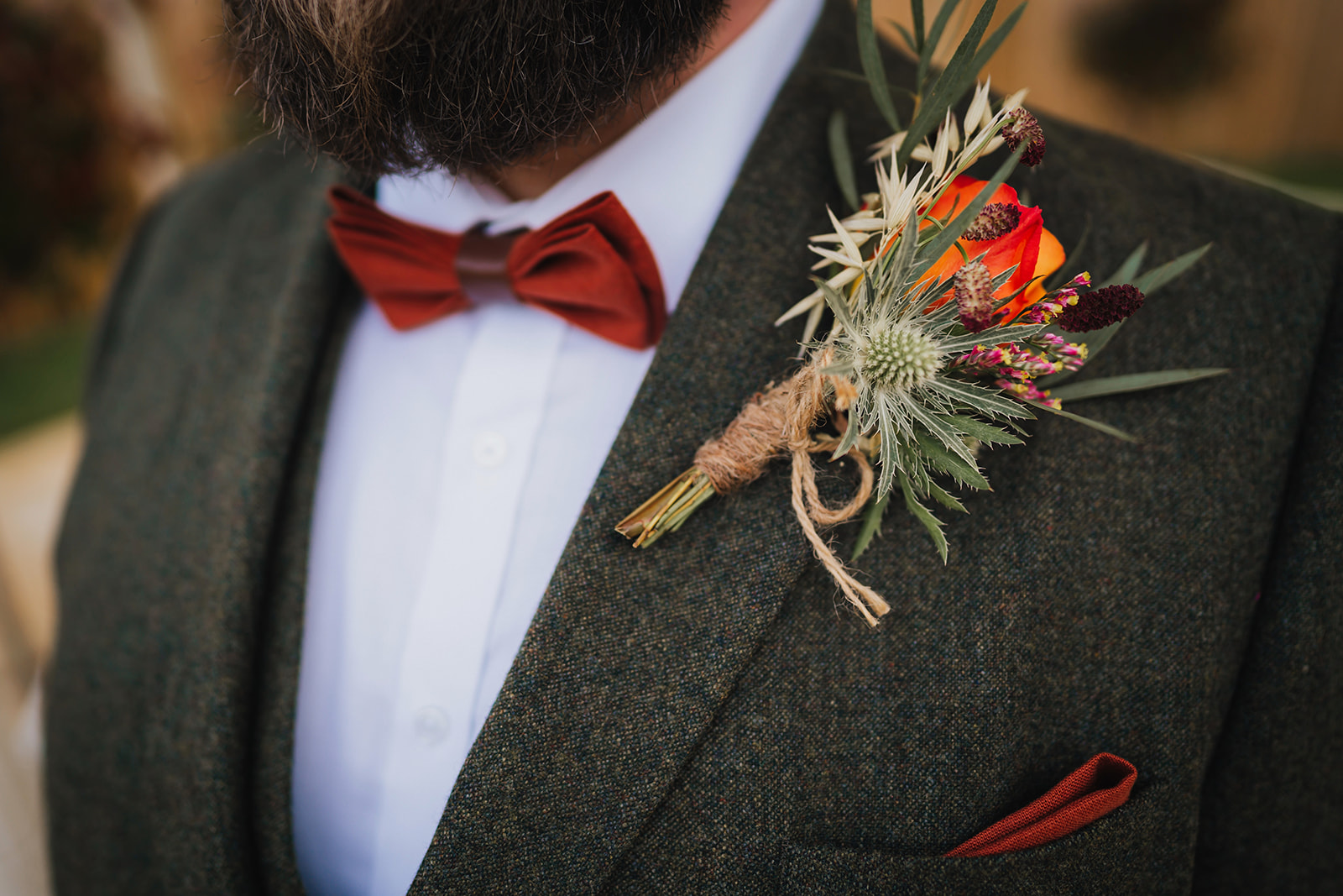the groom's buttonhole, pocket square and bow tie