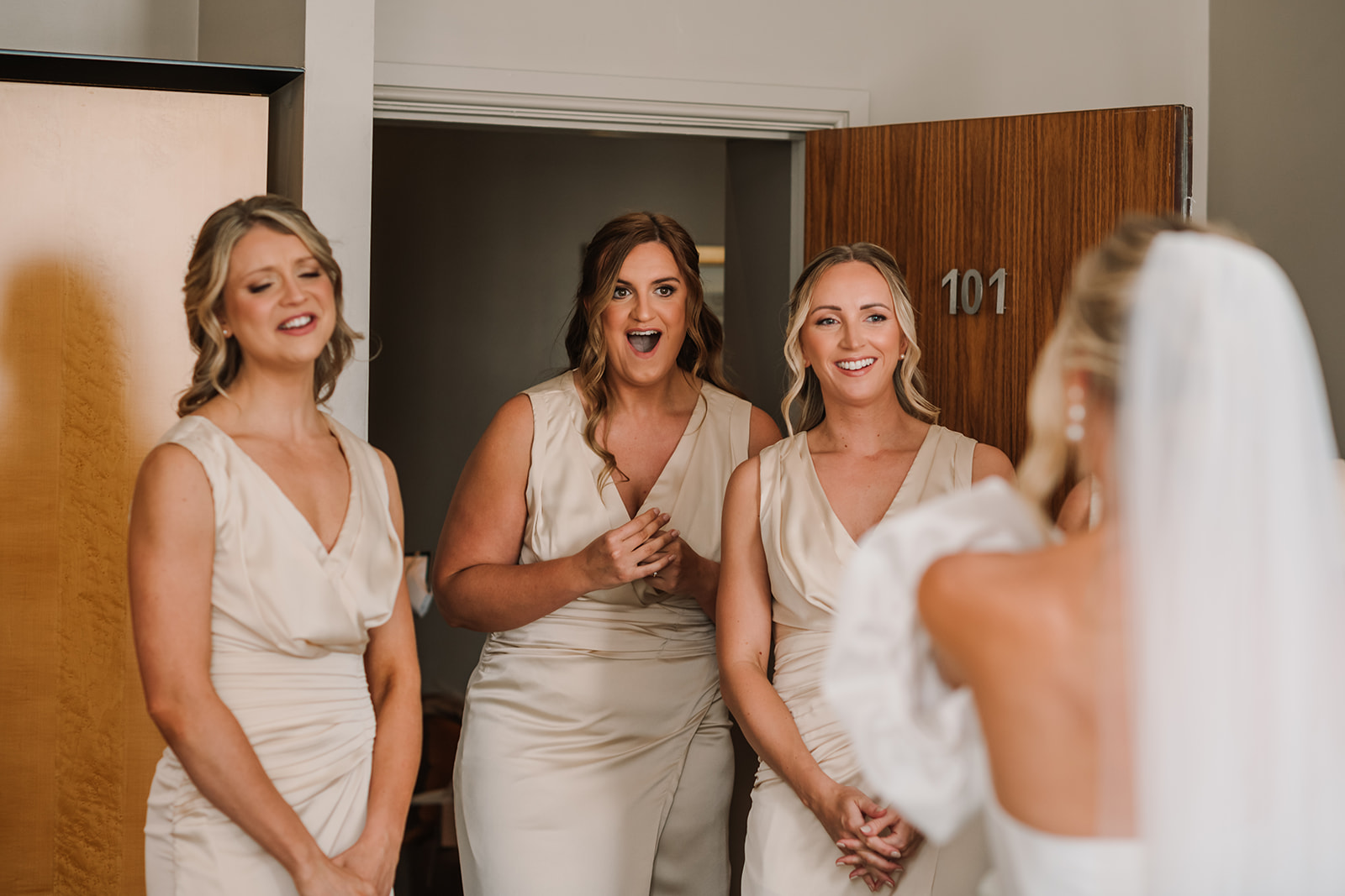 Bridesmaid reaction photo to beautiful Bride in Suzanne Neville dress.