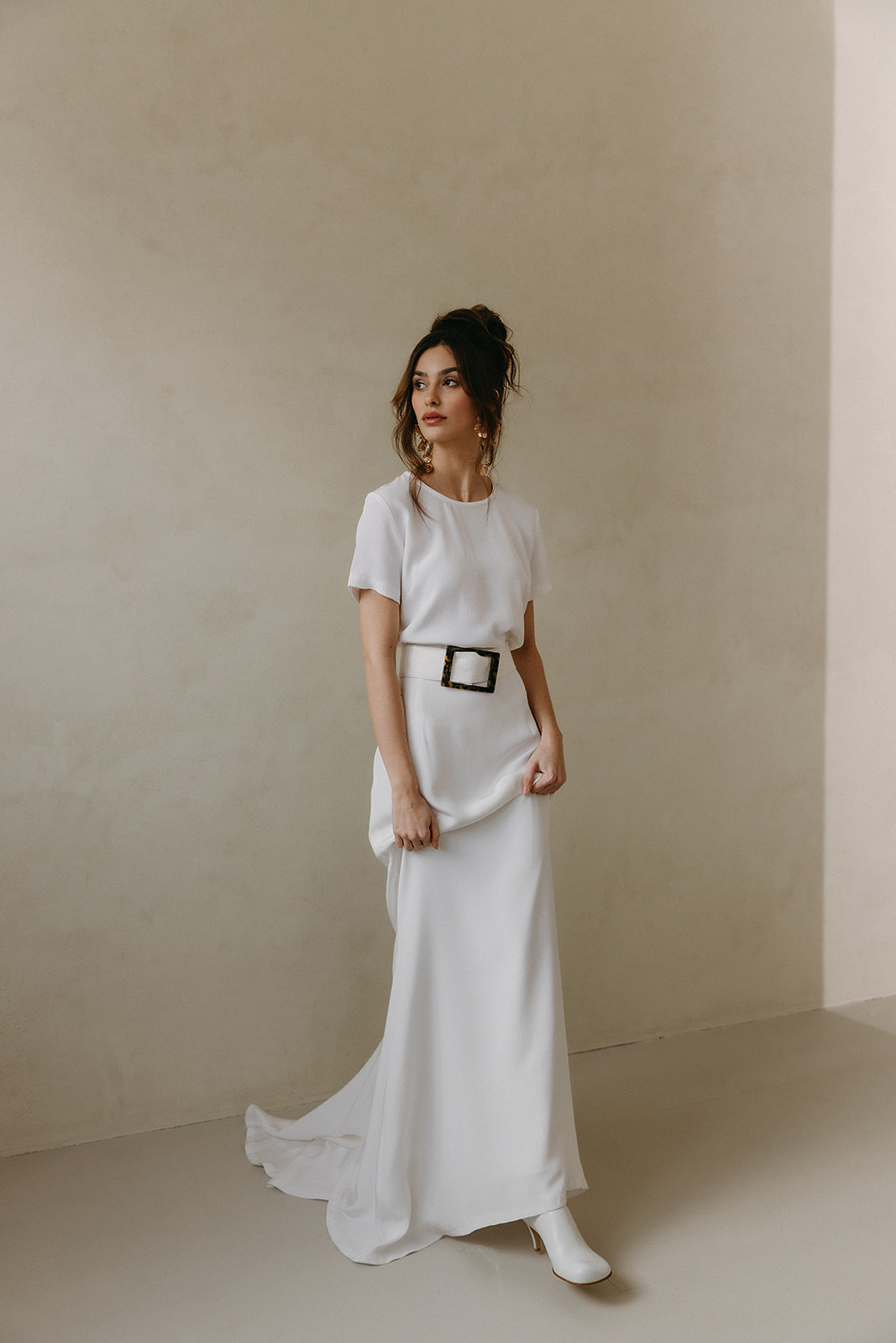 classy and minimal bridal t-shirt top and skirt with a belt. Bride is wearing Bottege Veneta Shoes