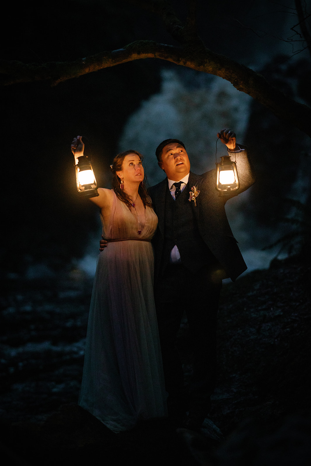 Mellie and Andrew pose for a photo with lanterns as their props for their Isle of Skye elopement photo shoot