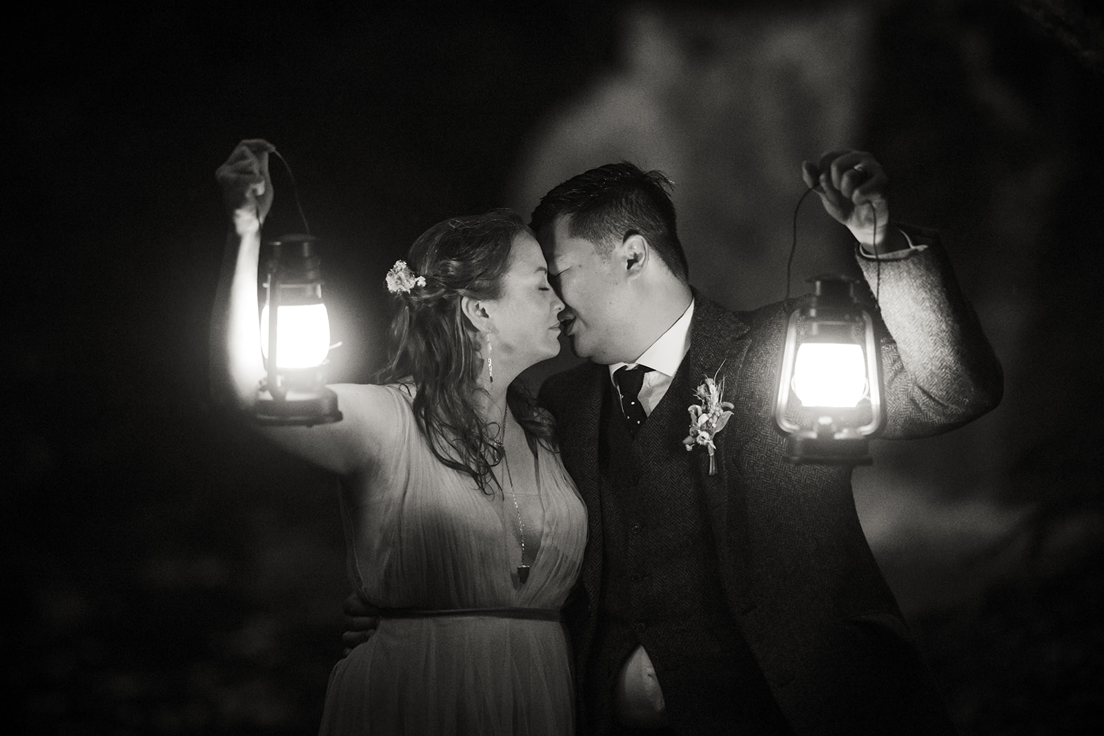 Mellie and Andrew pose for a photo with lanterns as their props for their Isle of Skye elopement photo shoot