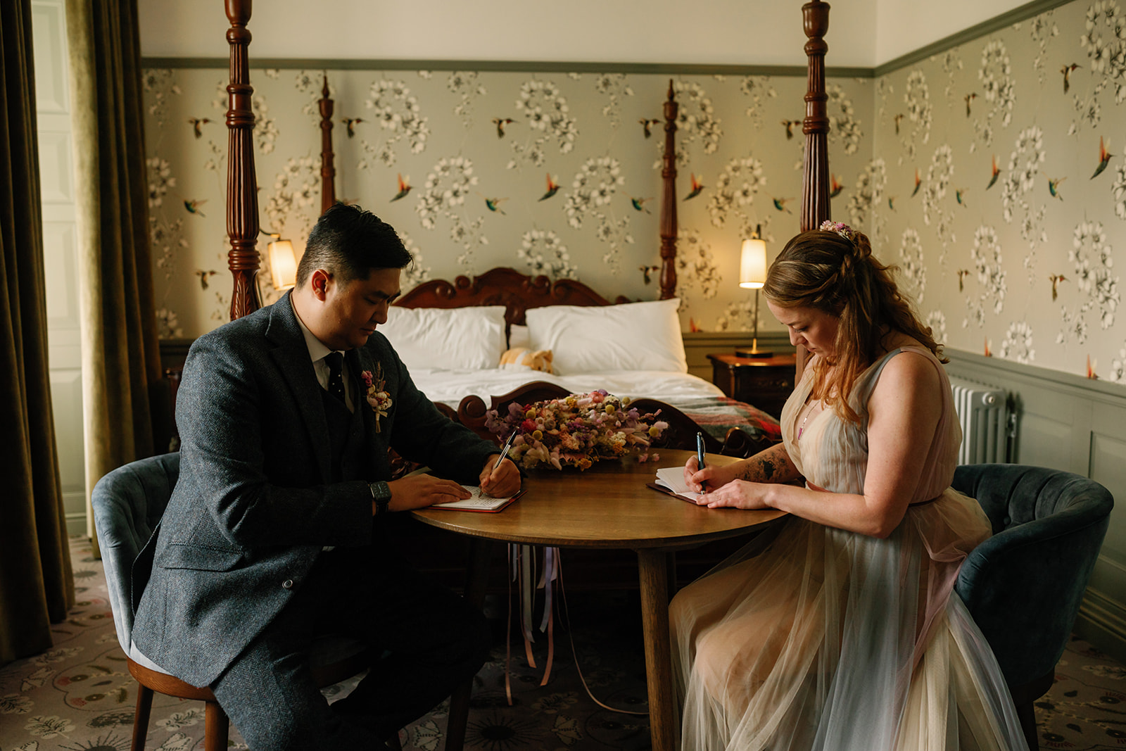 Mellie and Andrew sitting together writing their vows for their elopement at the Isle of Skye