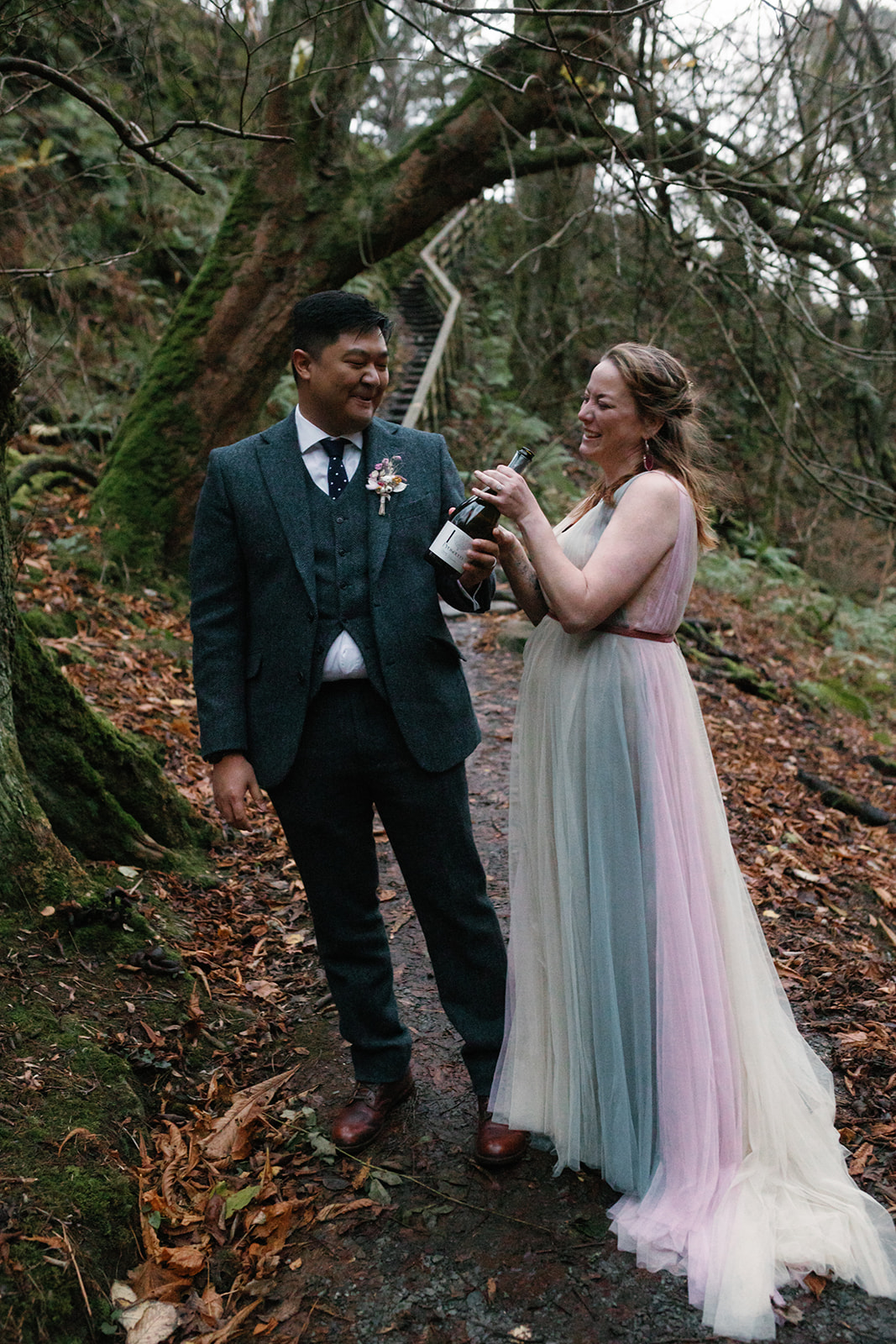 Newlyweds Mellie and Andrew celebrate their elopement on the picturesque Isle of Skye, popping a bottle of champagne