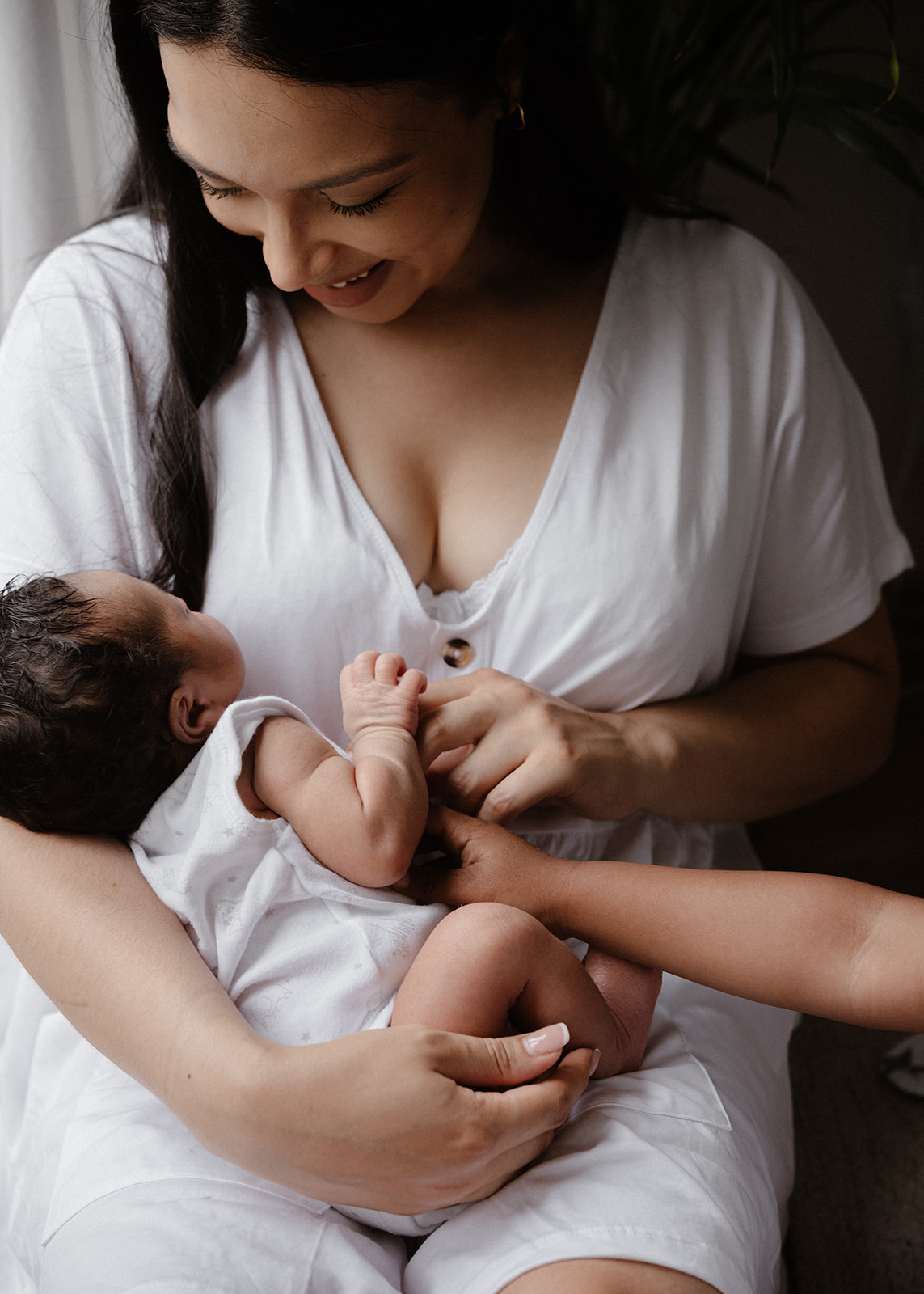 mum cuddling her son during a natural in-home newborn baby photoshoot 