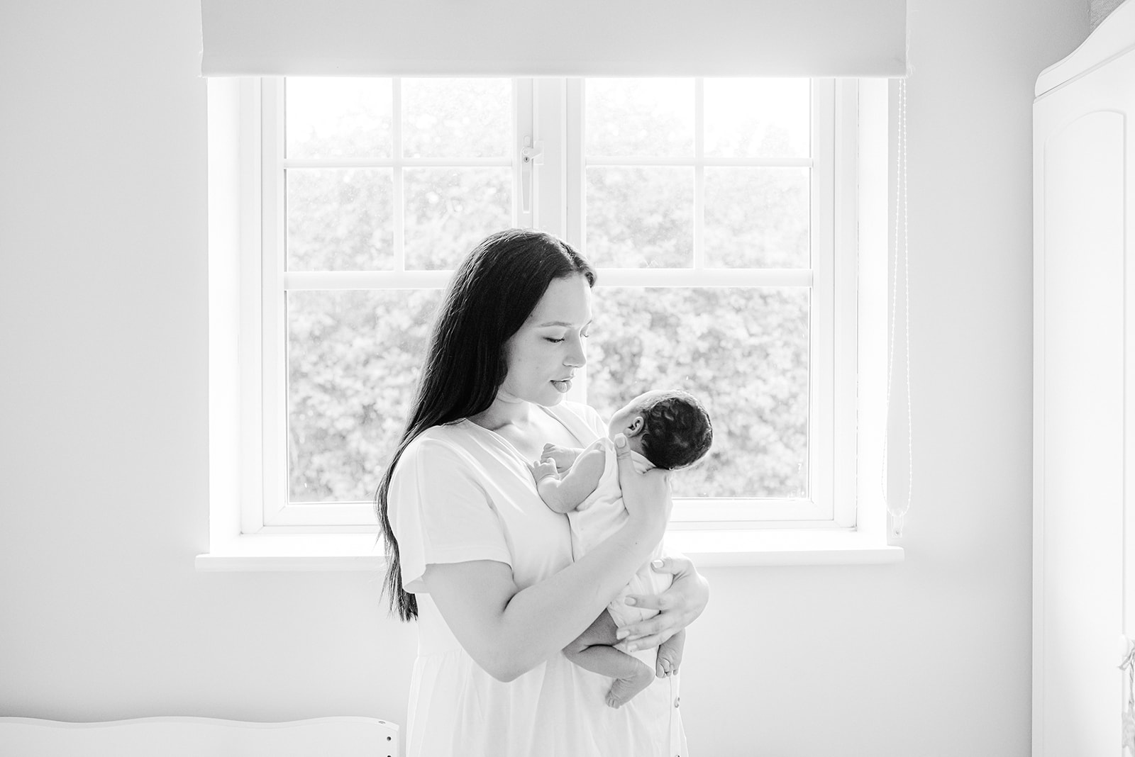 mum looking at her newborn baby son  during the natural newborn baby session in home in bristol by agi lebiedz