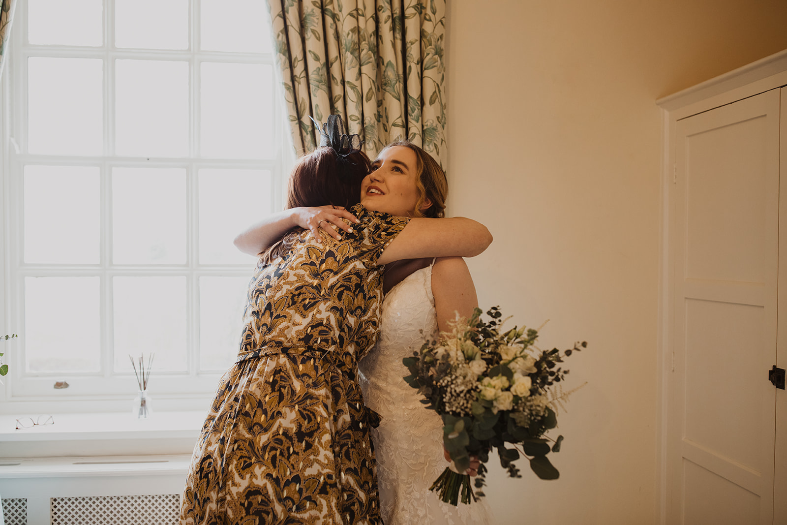 mother of the bride hugging the bride