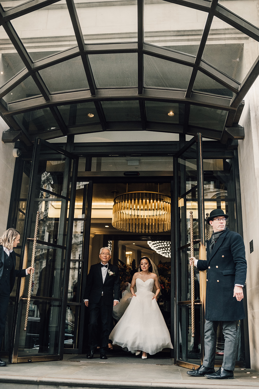 A bride and her father outside the Corinthia Hotel Luxury Wedding venue in London