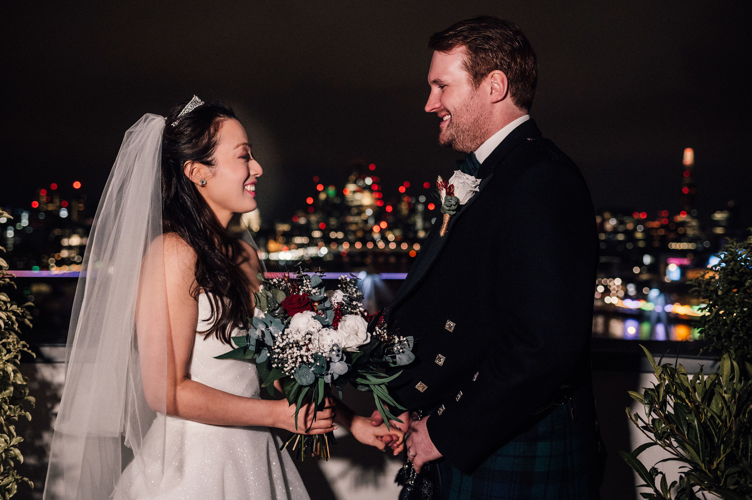 Bride and Groom on the roof of Corinthia Hotel with views of the London skyline at night.