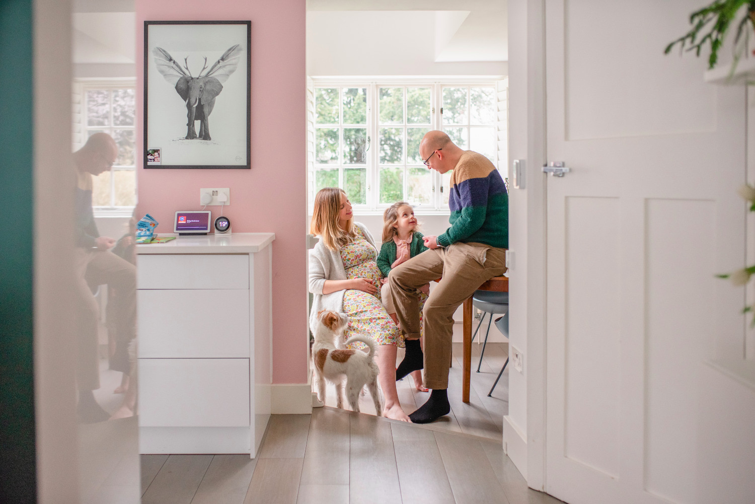 mum and dad with their daughter at their kitchen table during the natural maternity session by agi lebiedz