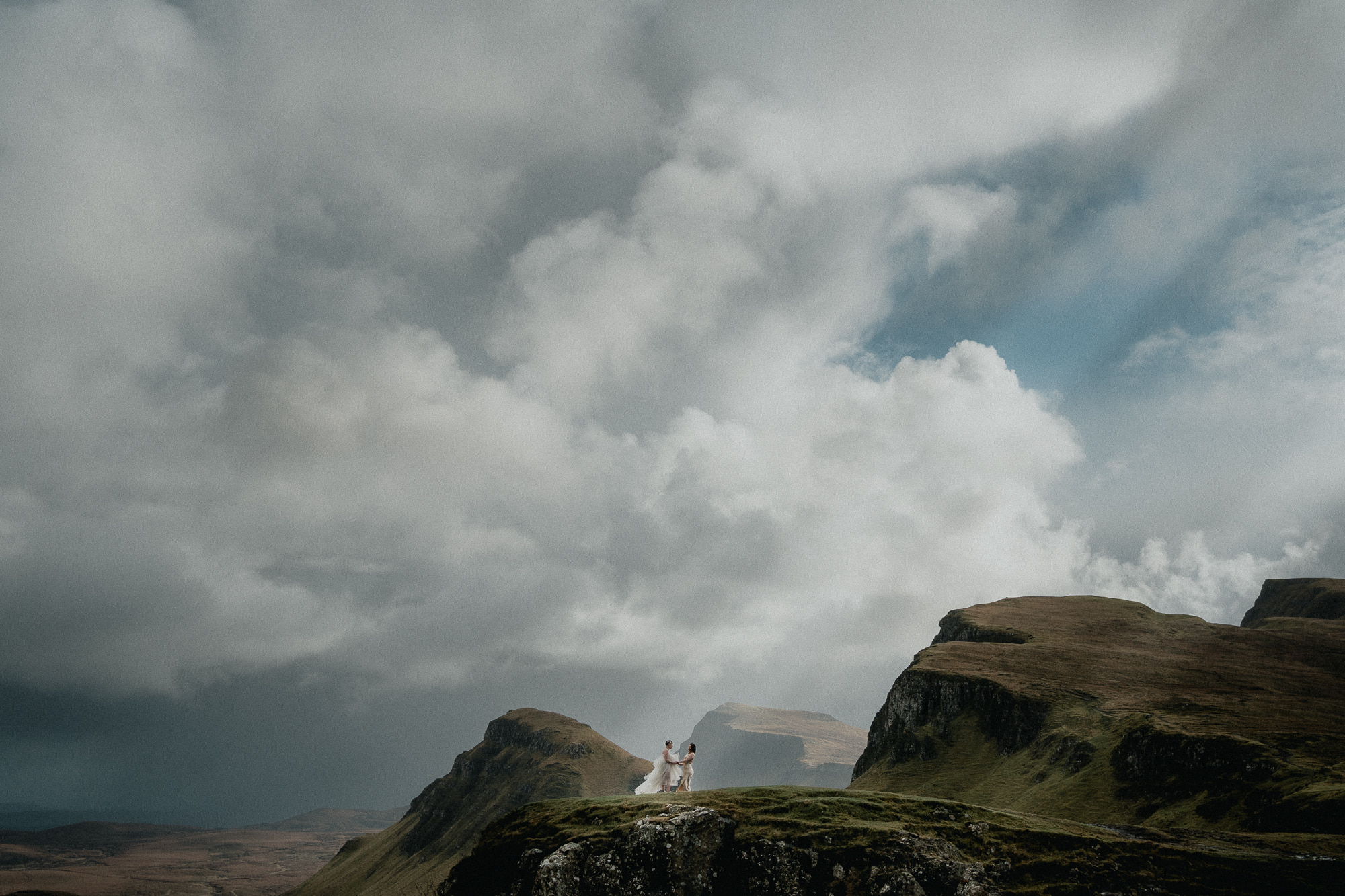 Couple stand atop the Quairaing on the Isle of Skye after their elopement