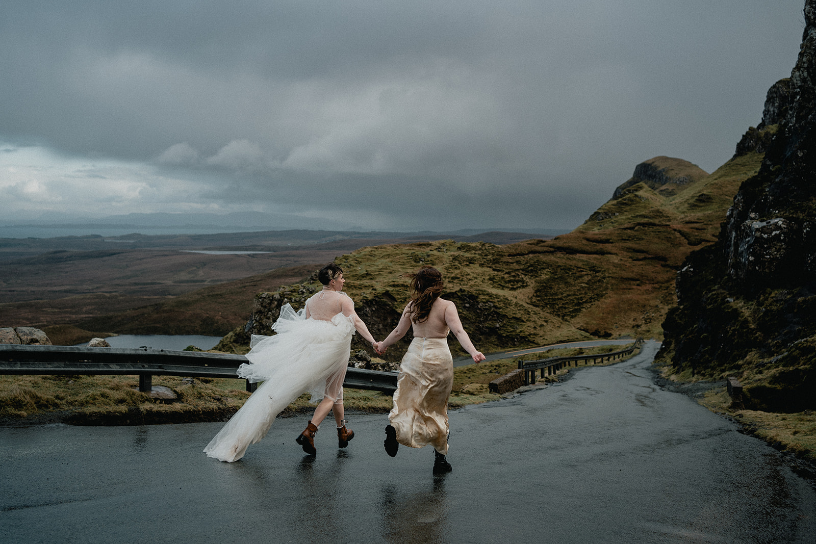 Same-sex couple run together after their elopement ceremony on the Isle of Skye