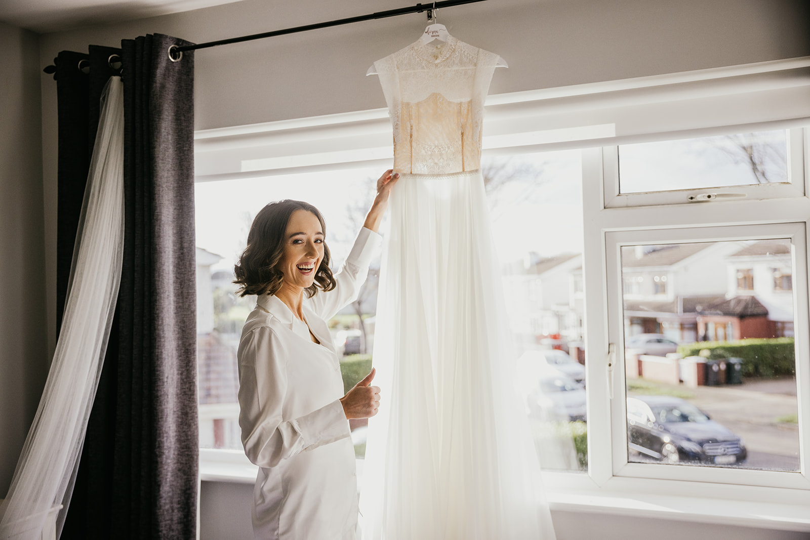 bride getting caught fixing her dress on the morning of her wedding.