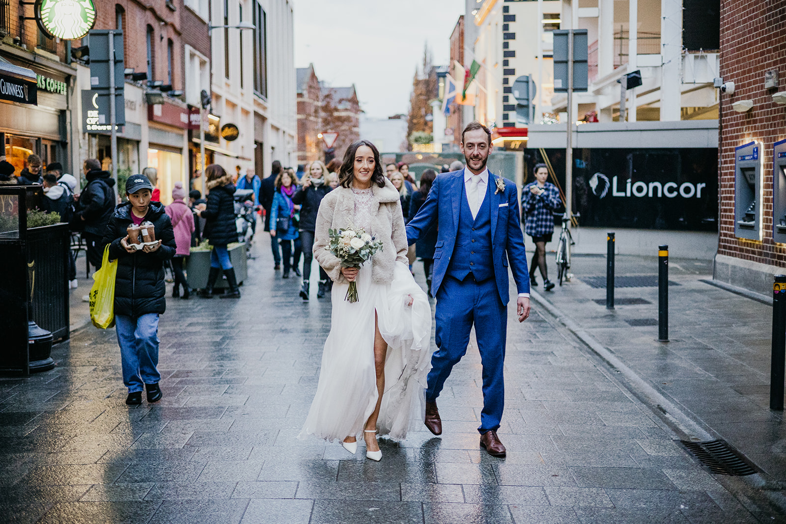 Couple getting their wedding photos on Grafton Street in Dublin near the Westbury hotel. 