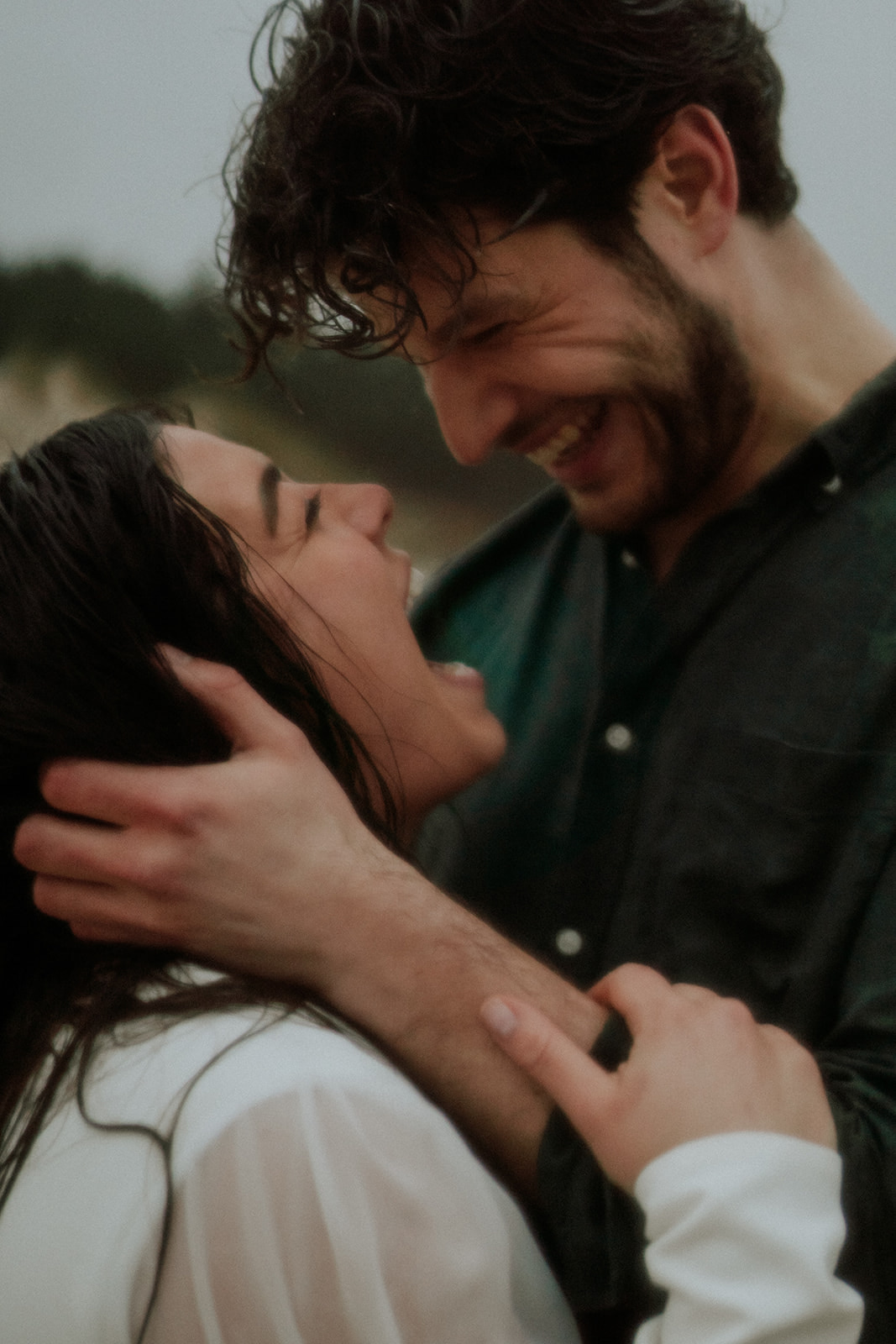 Eloping couple being happy in the rain