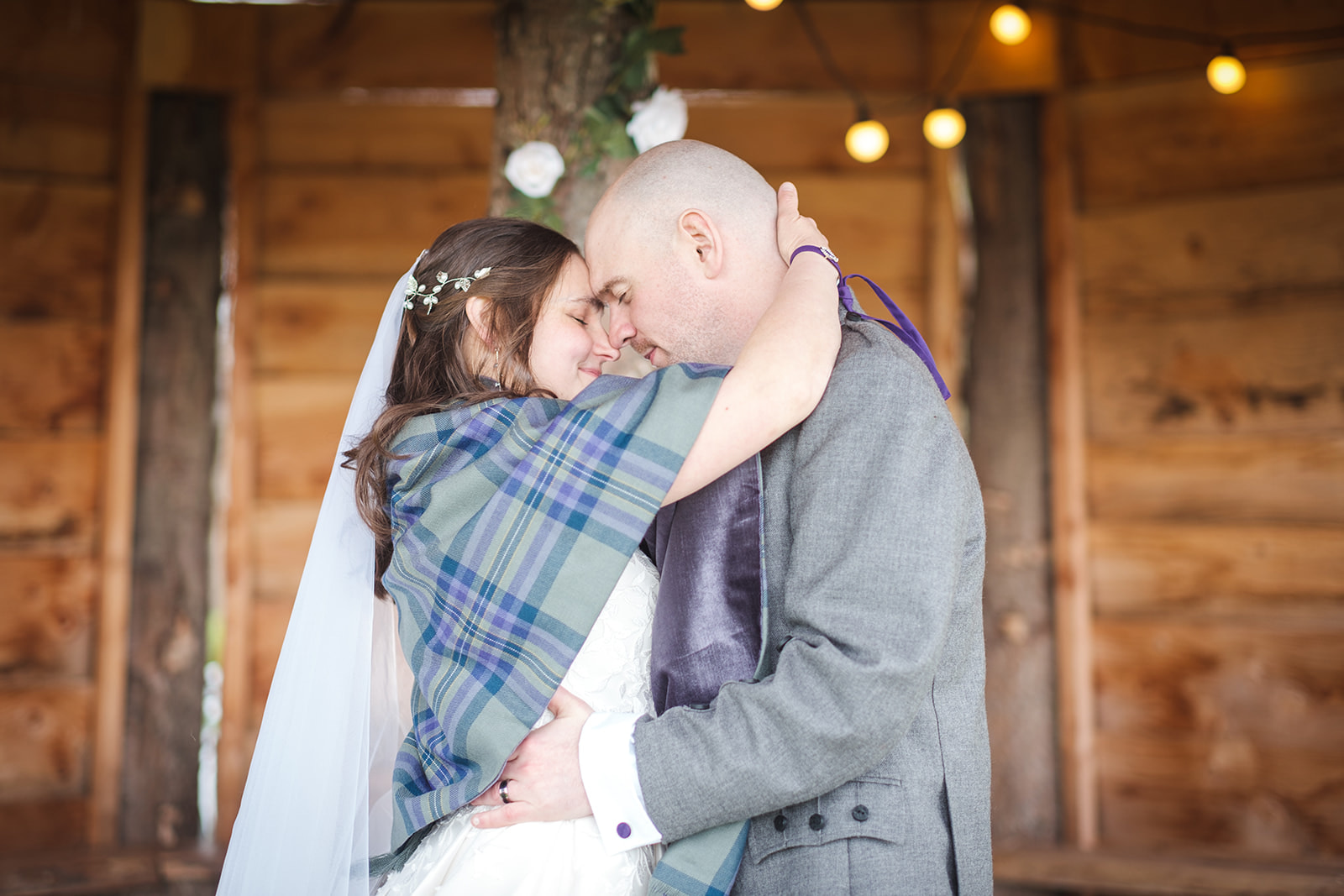 A couple holding each other on their wedding day, at Silverwood Lodges, in Perthshire, Scotland.