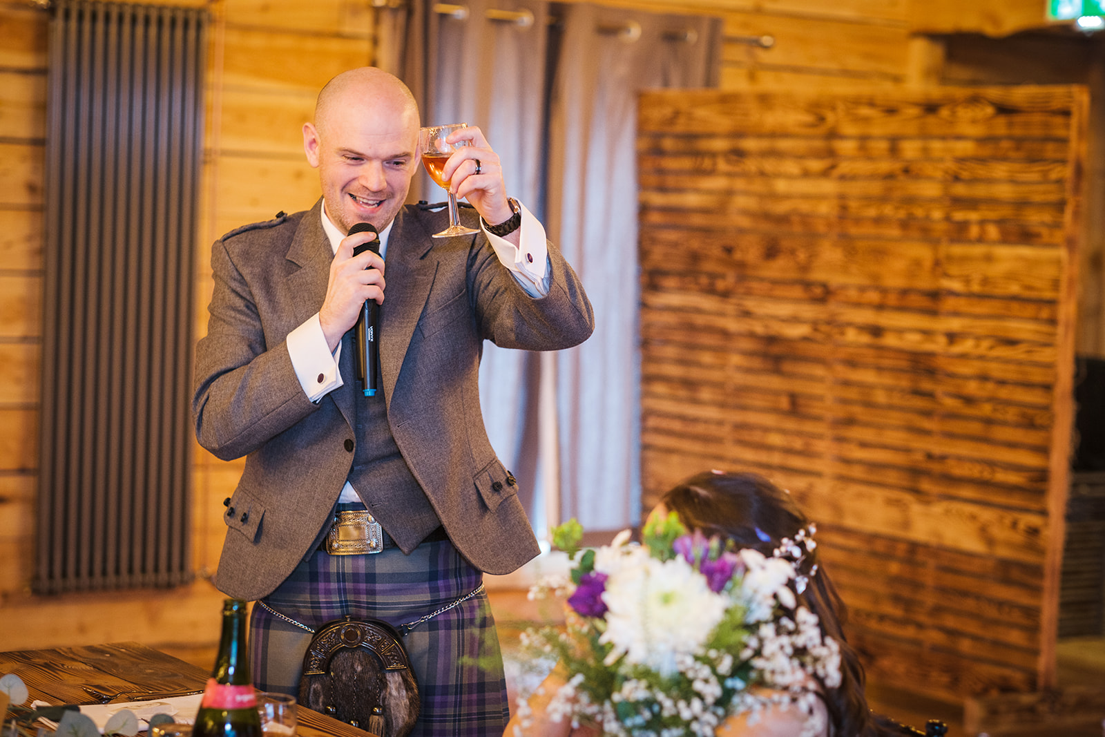 Groom offering up a toast to his beautiful bride at their wedding in Scotland.