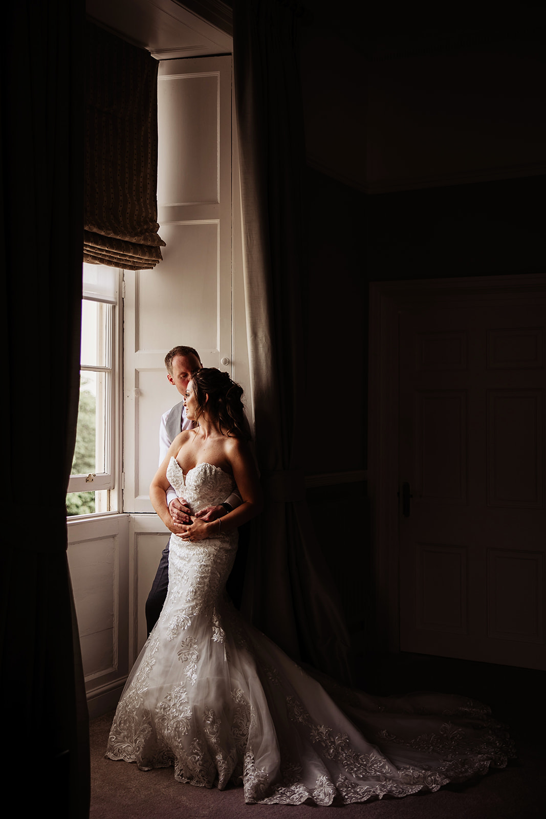 Bride and Groom in window of Honeymoon suite (Guildford suite) Farnham Castle