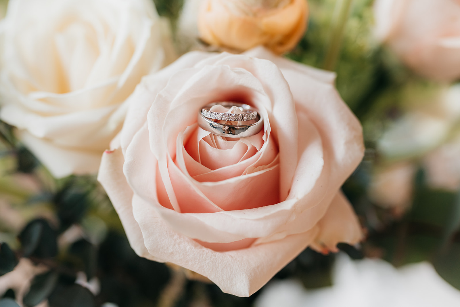 detail photograph of an engagement ring in a flower