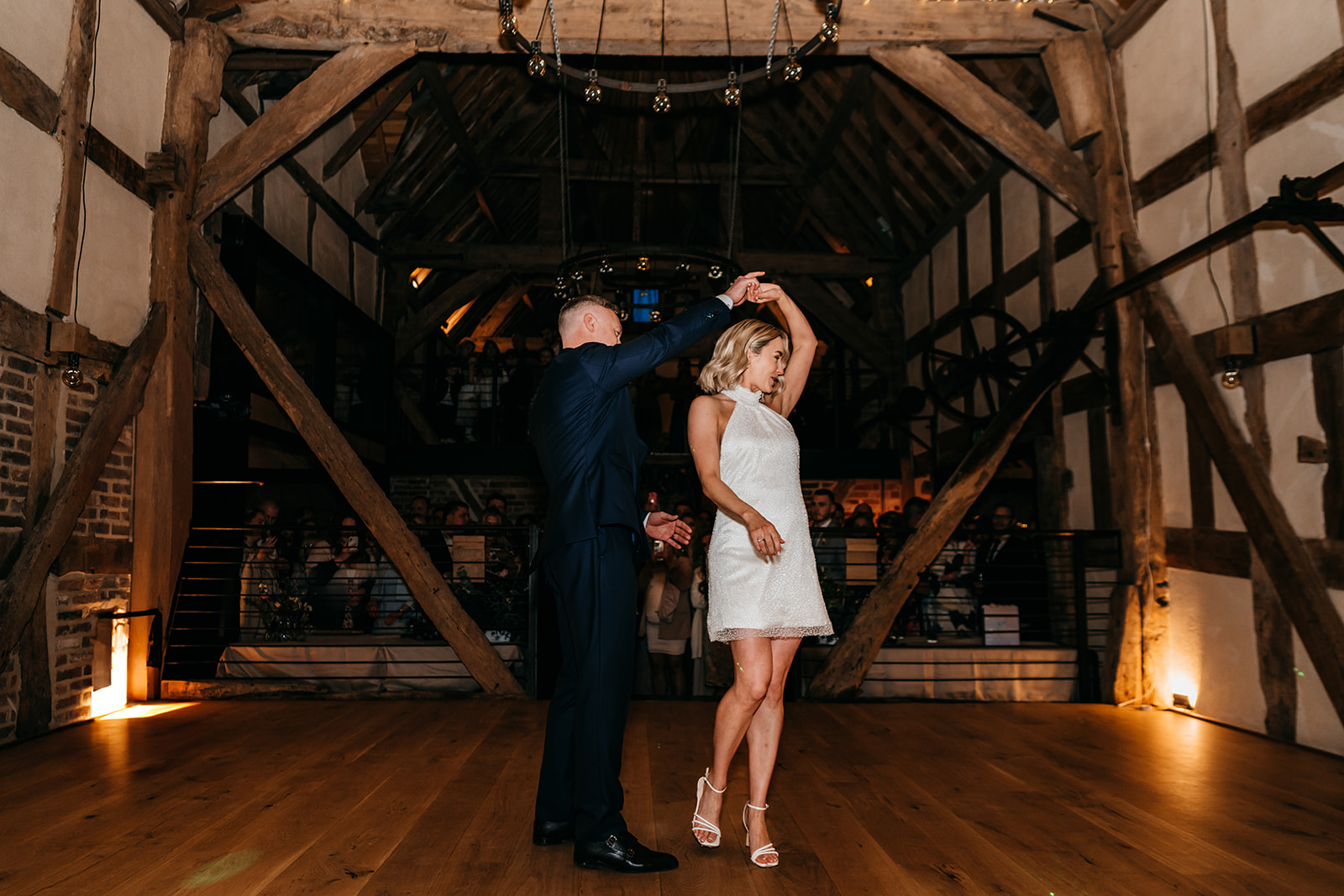 groom twirls his bride during the first dance 
