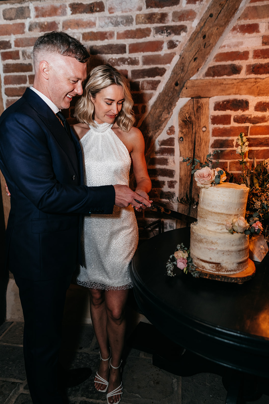 The bride and groom cut the wedding cake