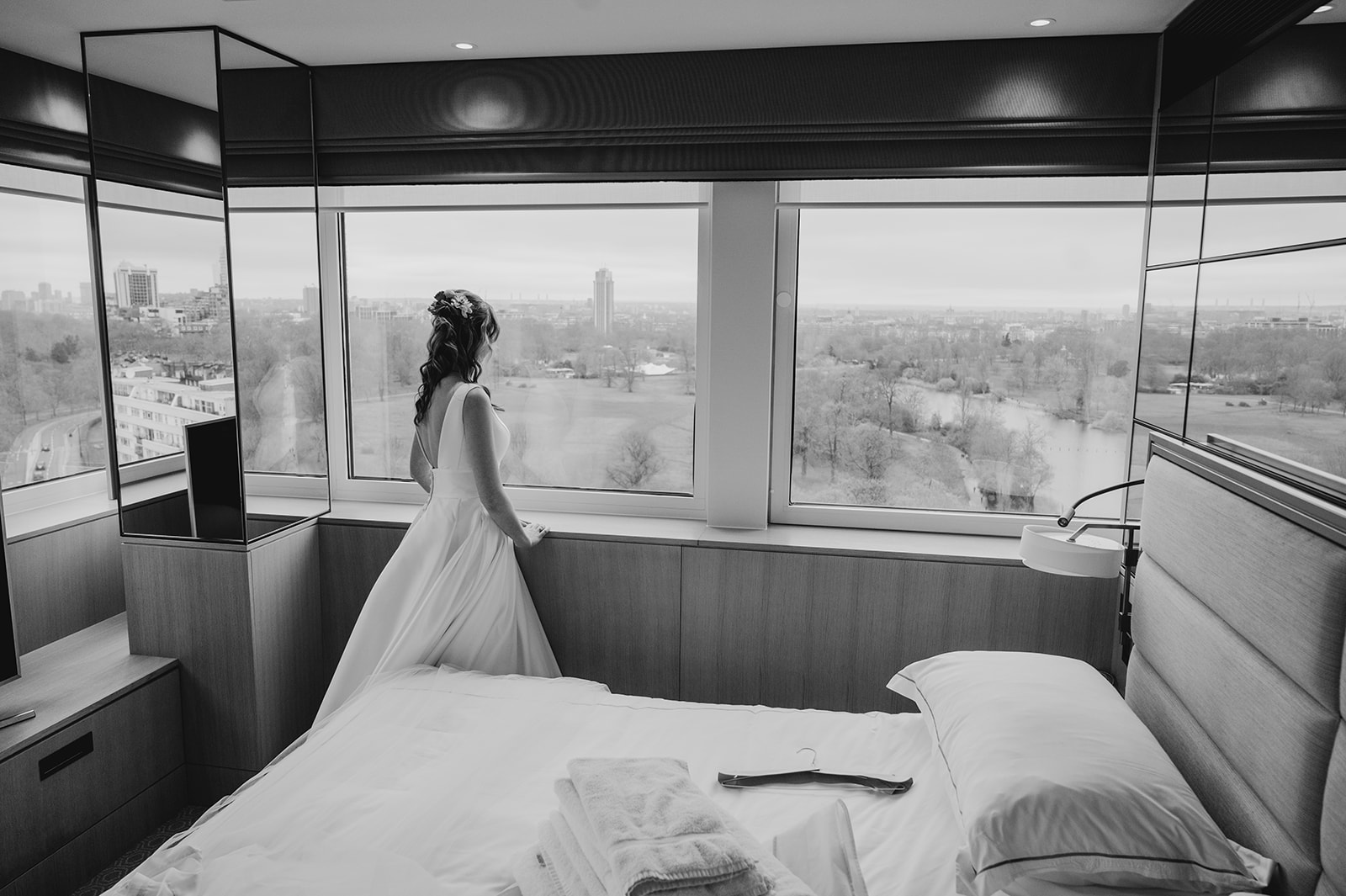 bride stands at window in royal Lancaster hotel London 