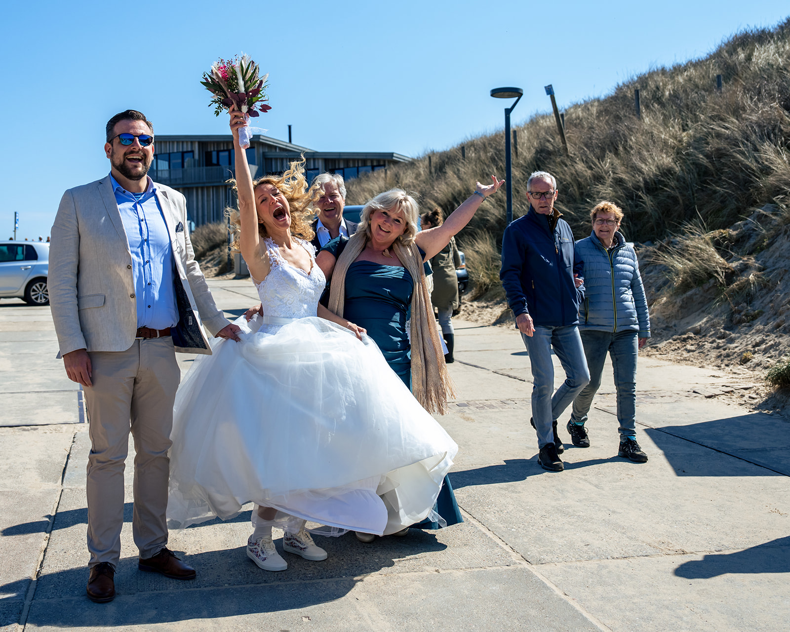 Bride arriving at the beach side on her wedding day. Celebrating at Club Zand in Castricum aan Zee