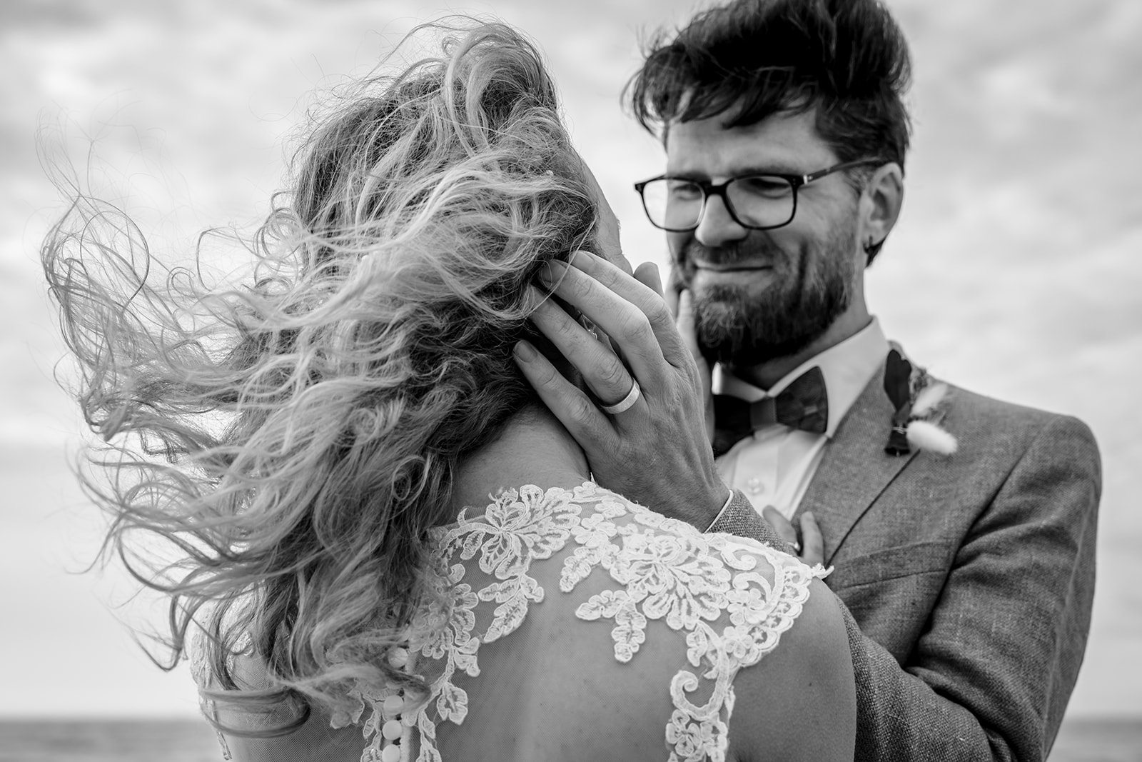 True love on your wedding day in black and white image. Wind blowing in the brides hair and ready to kiss