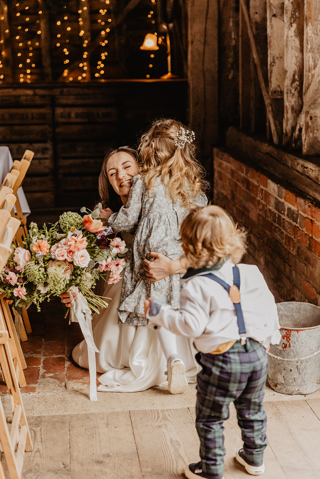 Bride with children at a Secret Barn Wedding, West Sussex. By Olive Joy Photography