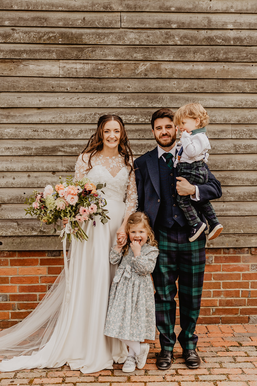 bride and groom with children at a Secret Barn Wedding, West Sussex. By Olive Joy Photography