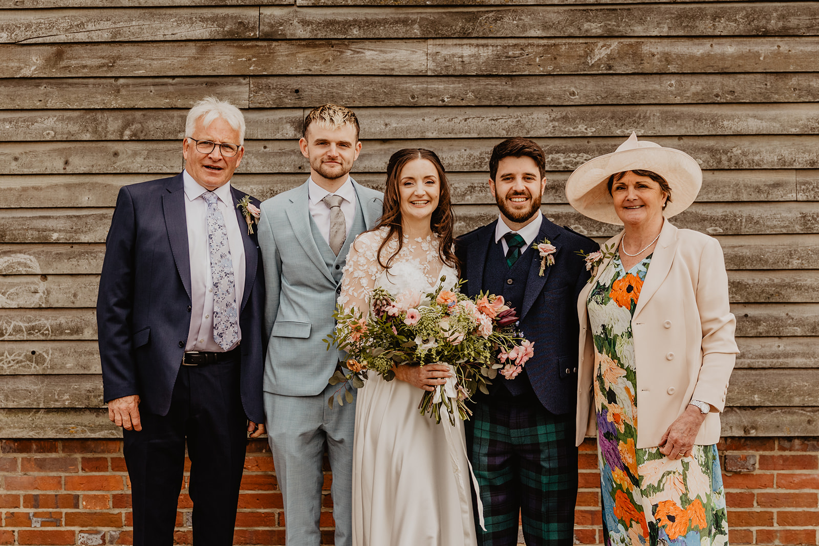 Bride and groom and family at a Secret Barn Wedding, West Sussex. By Olive Joy Photography