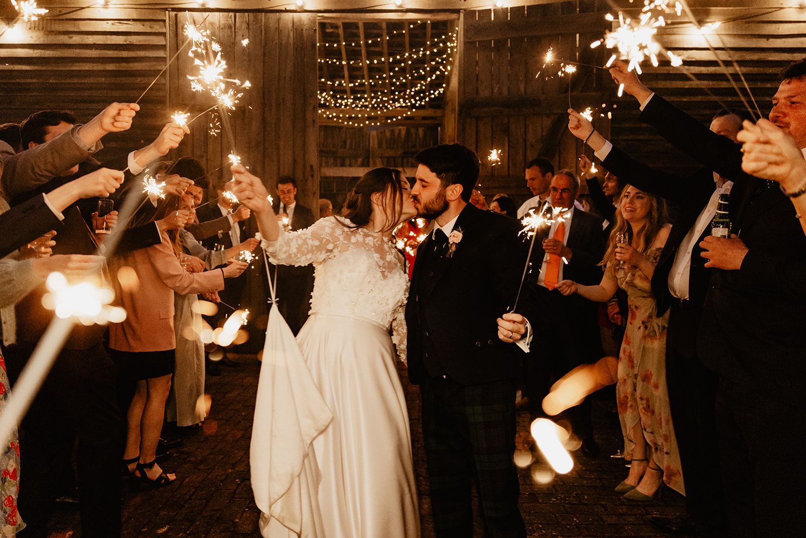 Bride and groom  under sparklers at a Secret Barn Wedding, West Sussex. By Olive Joy Photography