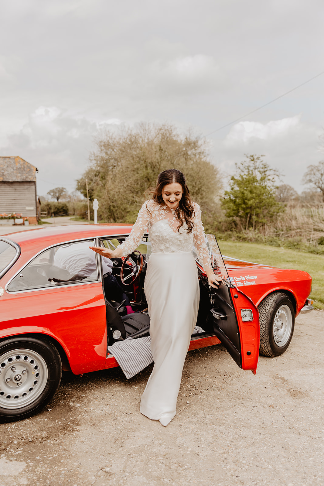 Bride in wedding car at a Secret Barn Wedding, West Sussex. By Olive Joy Photography