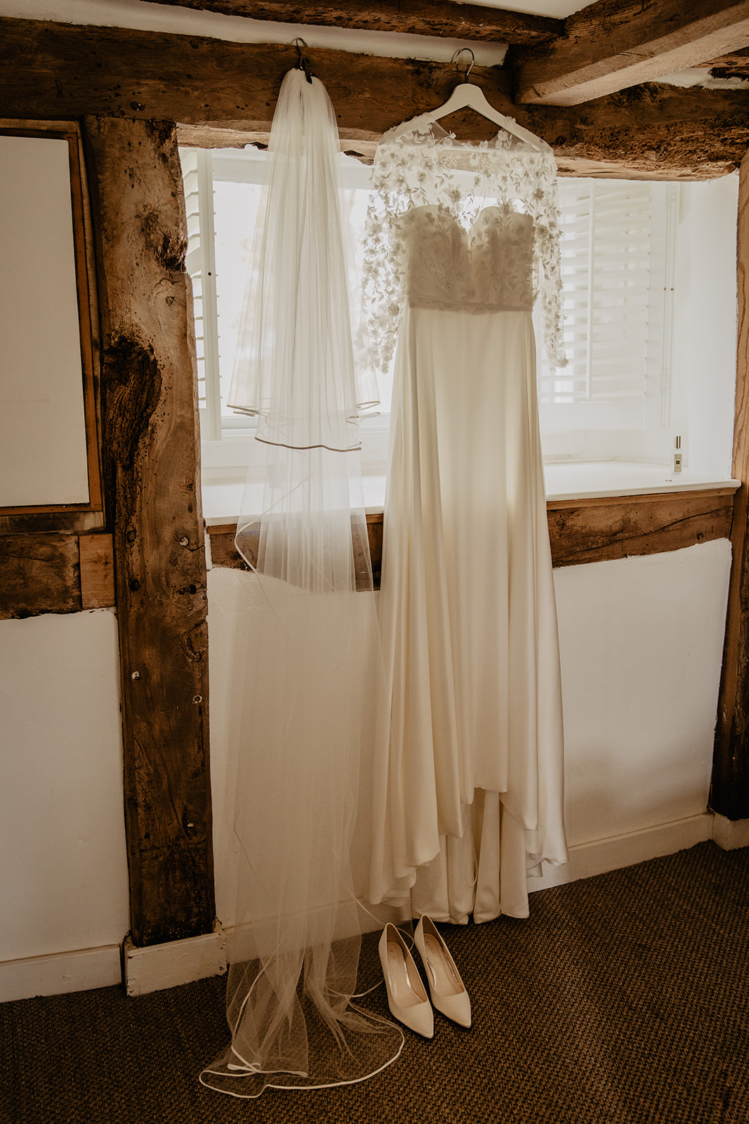 Wedding Dress hanging at a Secret Barn Wedding, West Sussex. By Olive Joy Photography