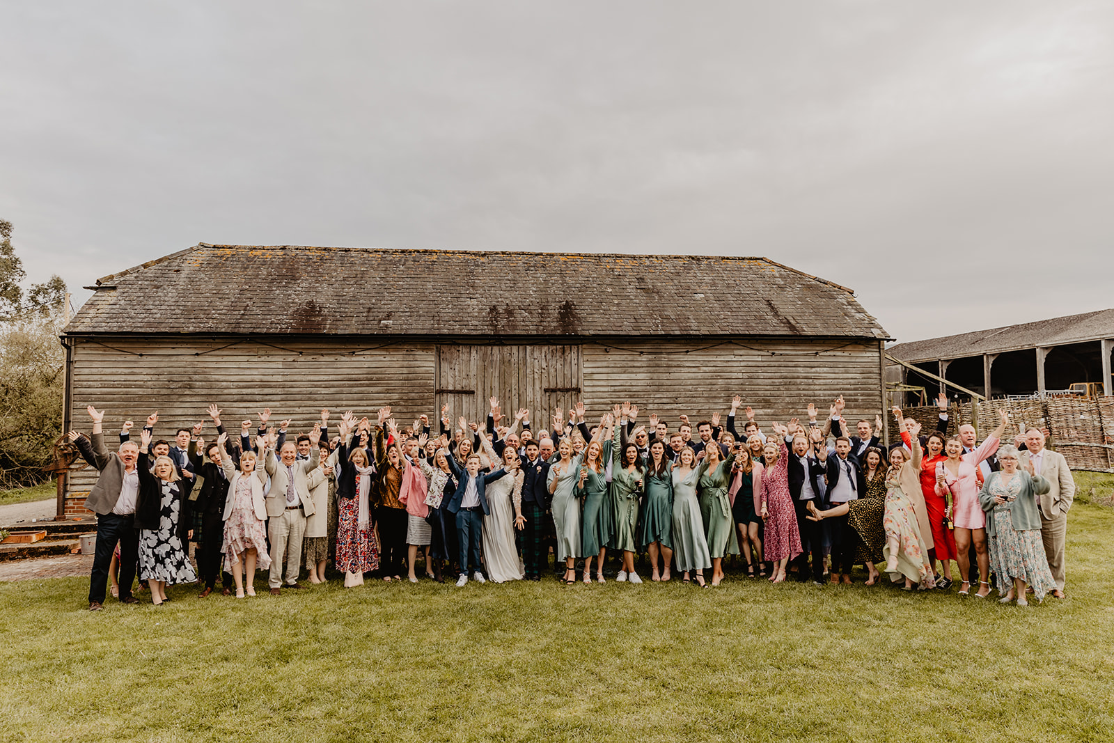 Wedding guests group photo at a Secret Barn Wedding, West Sussex. By Olive Joy Photography