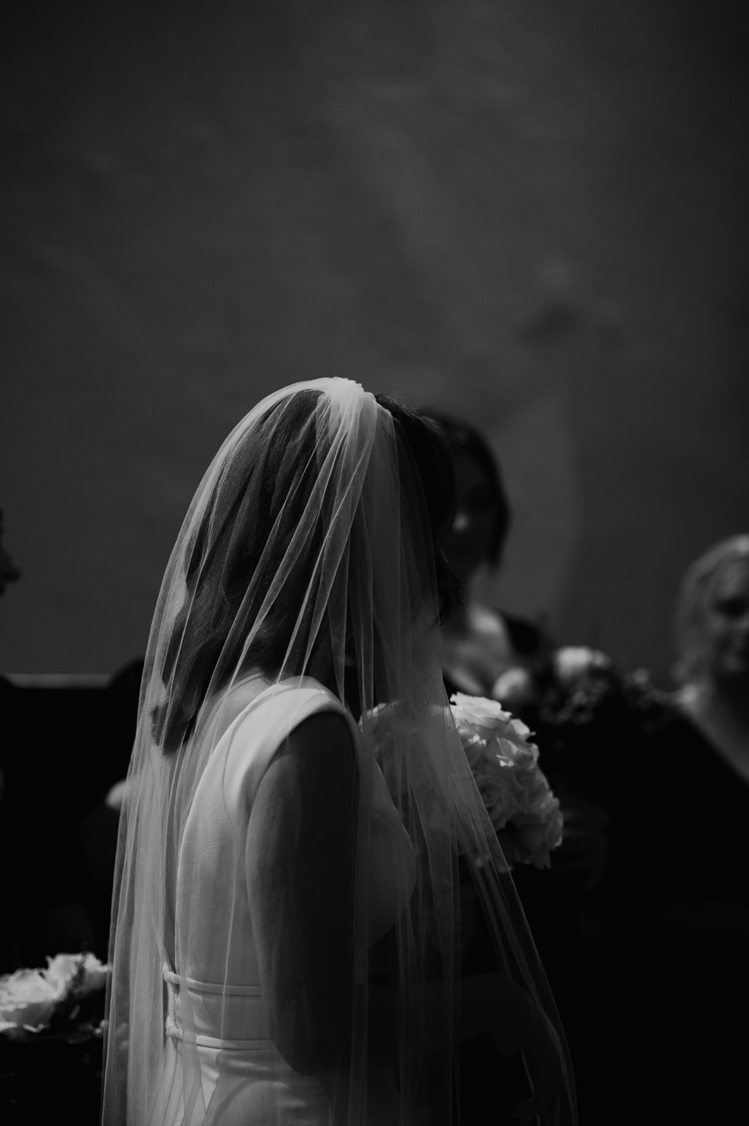 black and white silhouette of bride wearing veil at church wedding in Brighton 
