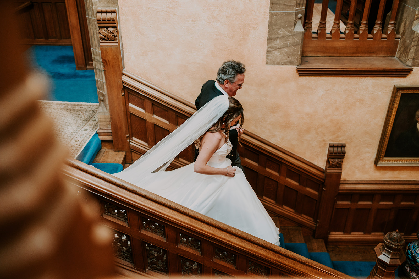 bride and father of bride walking down staircase in summer wedding at cowdray house 
