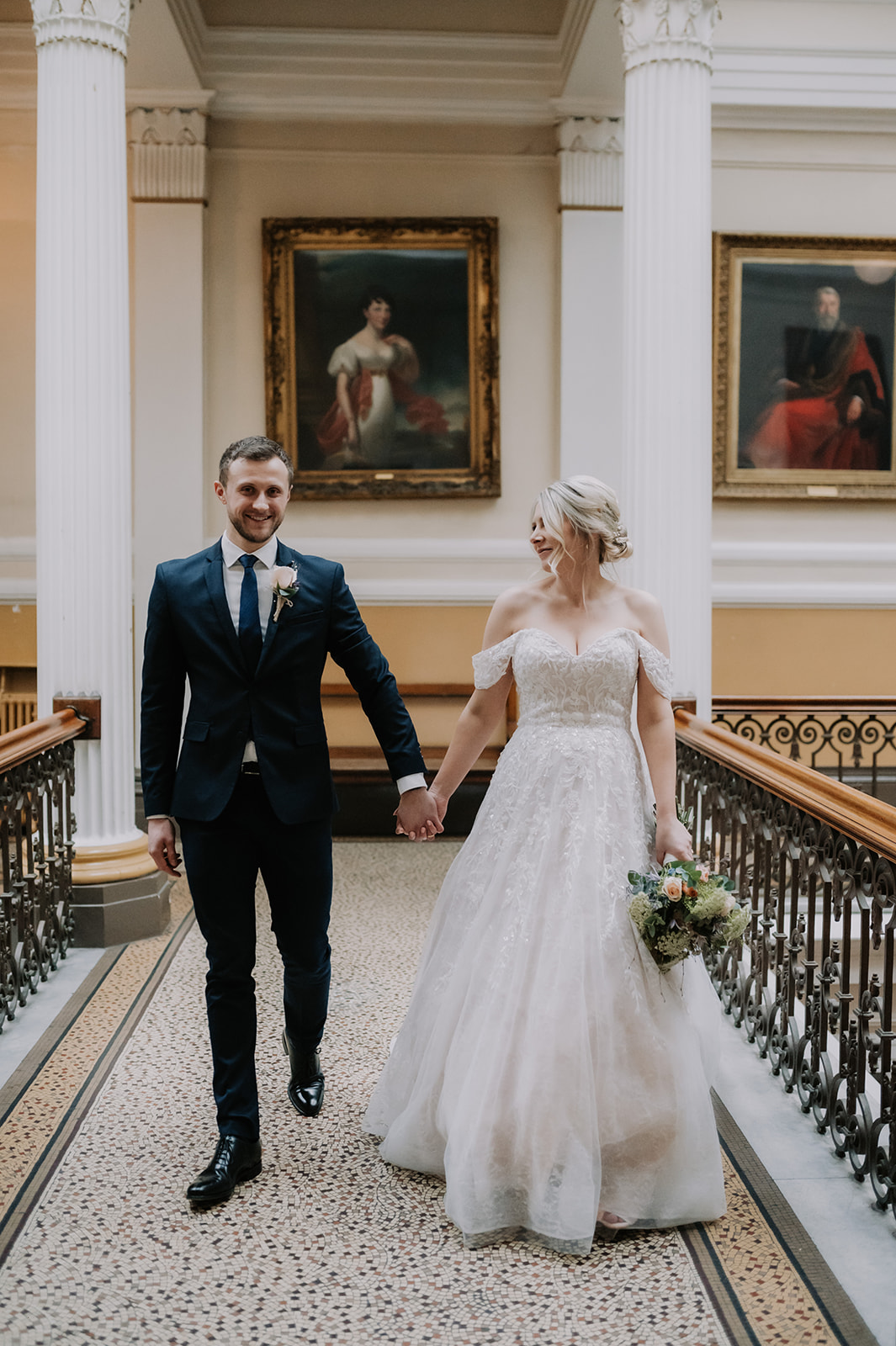 bride and groom holding hands walking in brighton town hall spring wedding
