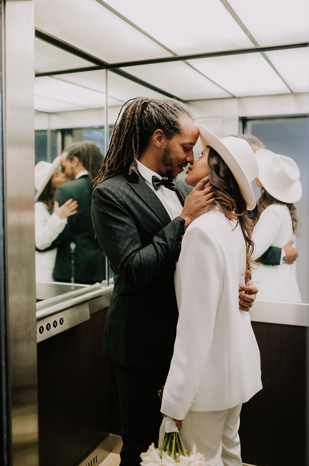 bride and groom kissing in lift in city brighton elopement 