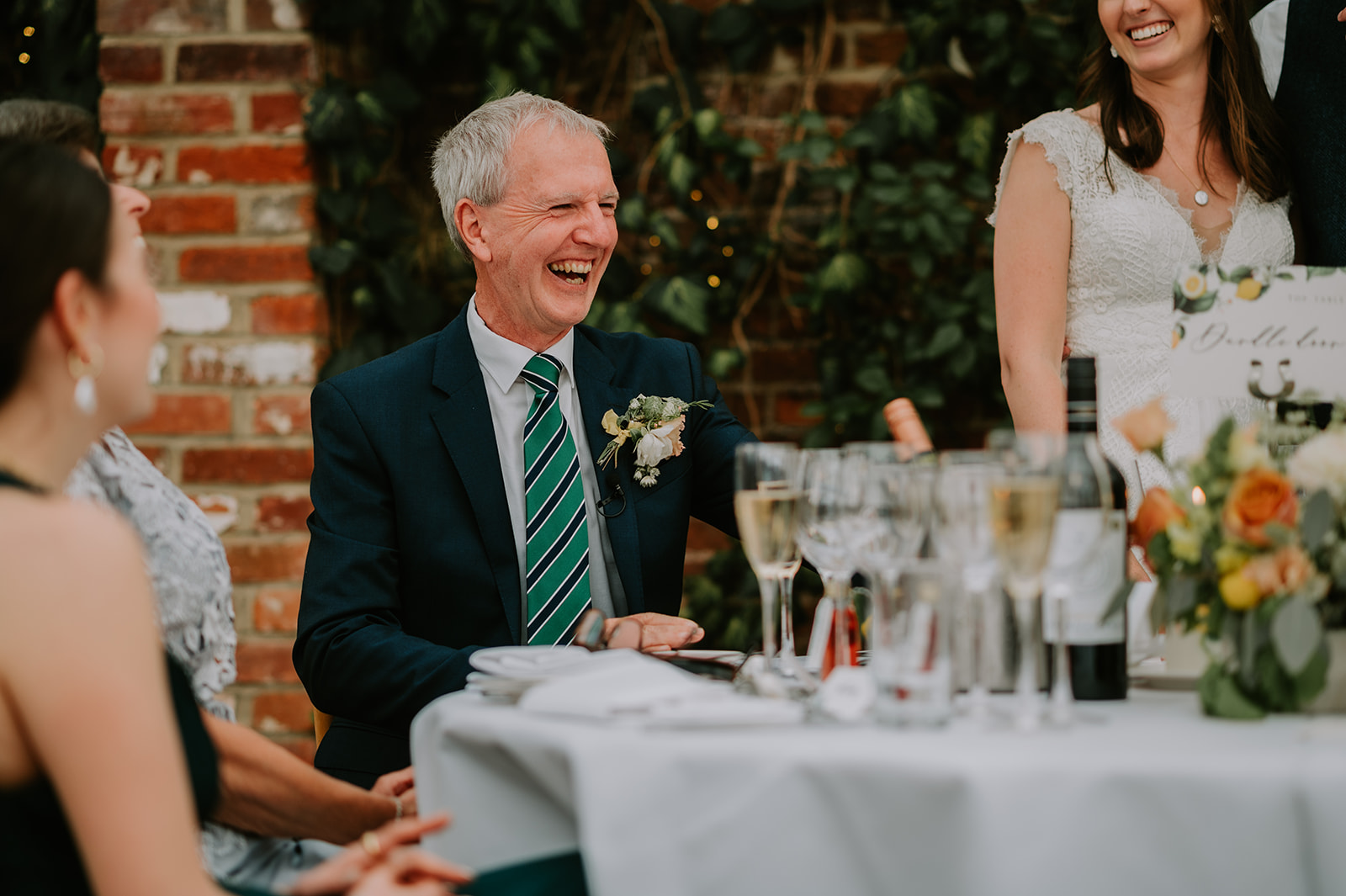 father of bride laughing during speech at spring northbrook park wedding 