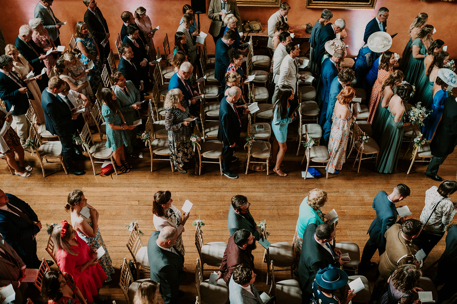 guests during ceremony at cowdray house in summer wedding 