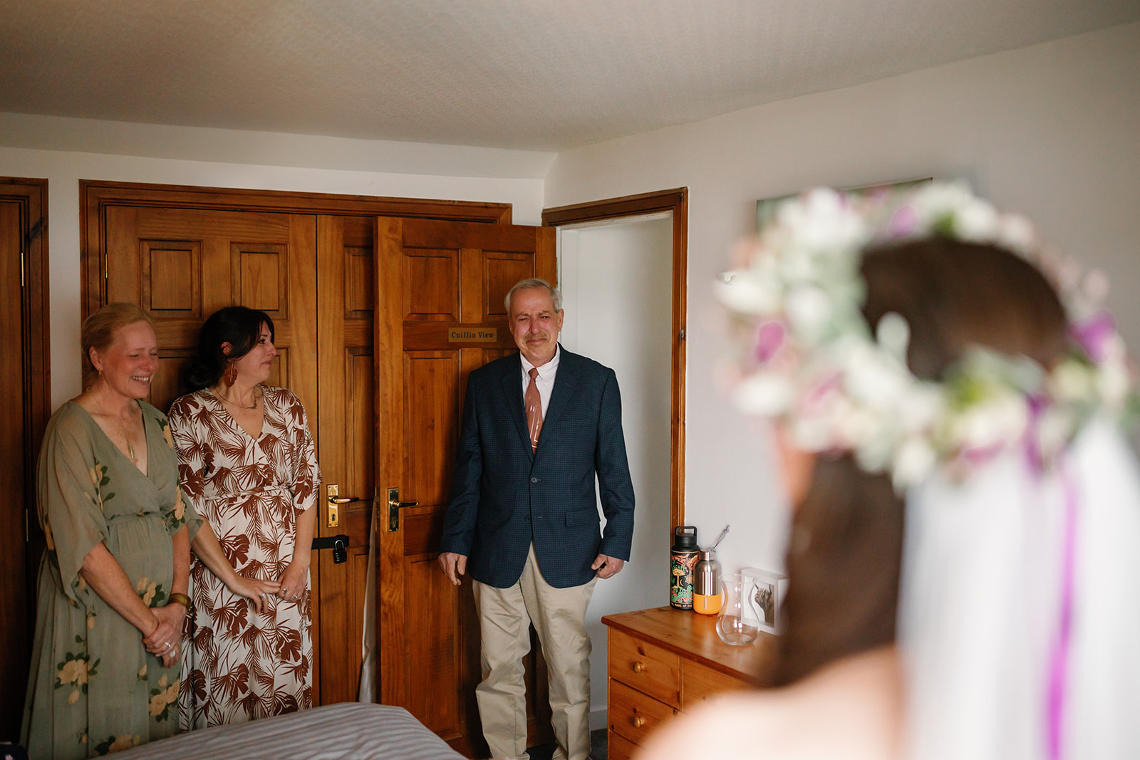 Bride Becca, emotionally embraced by her father, shares a first look moment during their Isle of elopement day